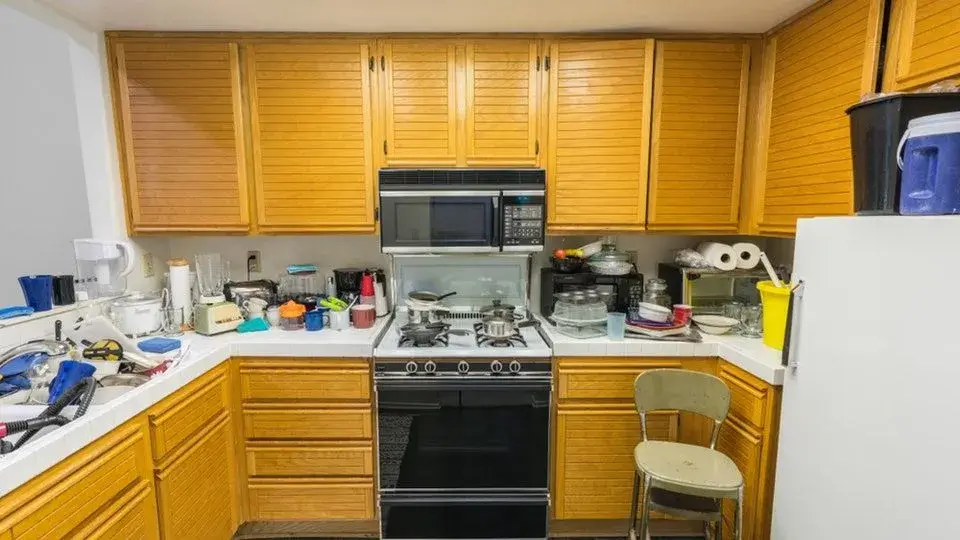 A dated, cluttered kitchen before renovation