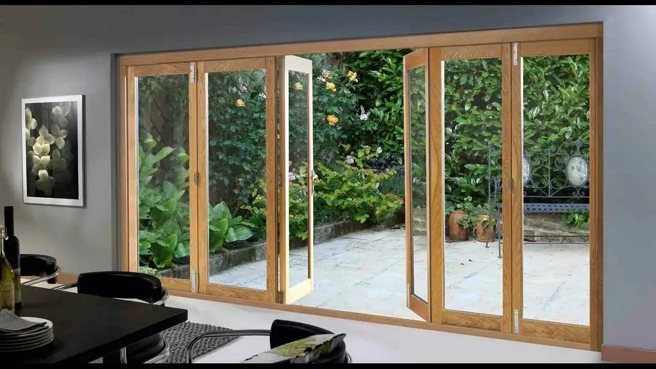 A large glass door opening to a serene garden