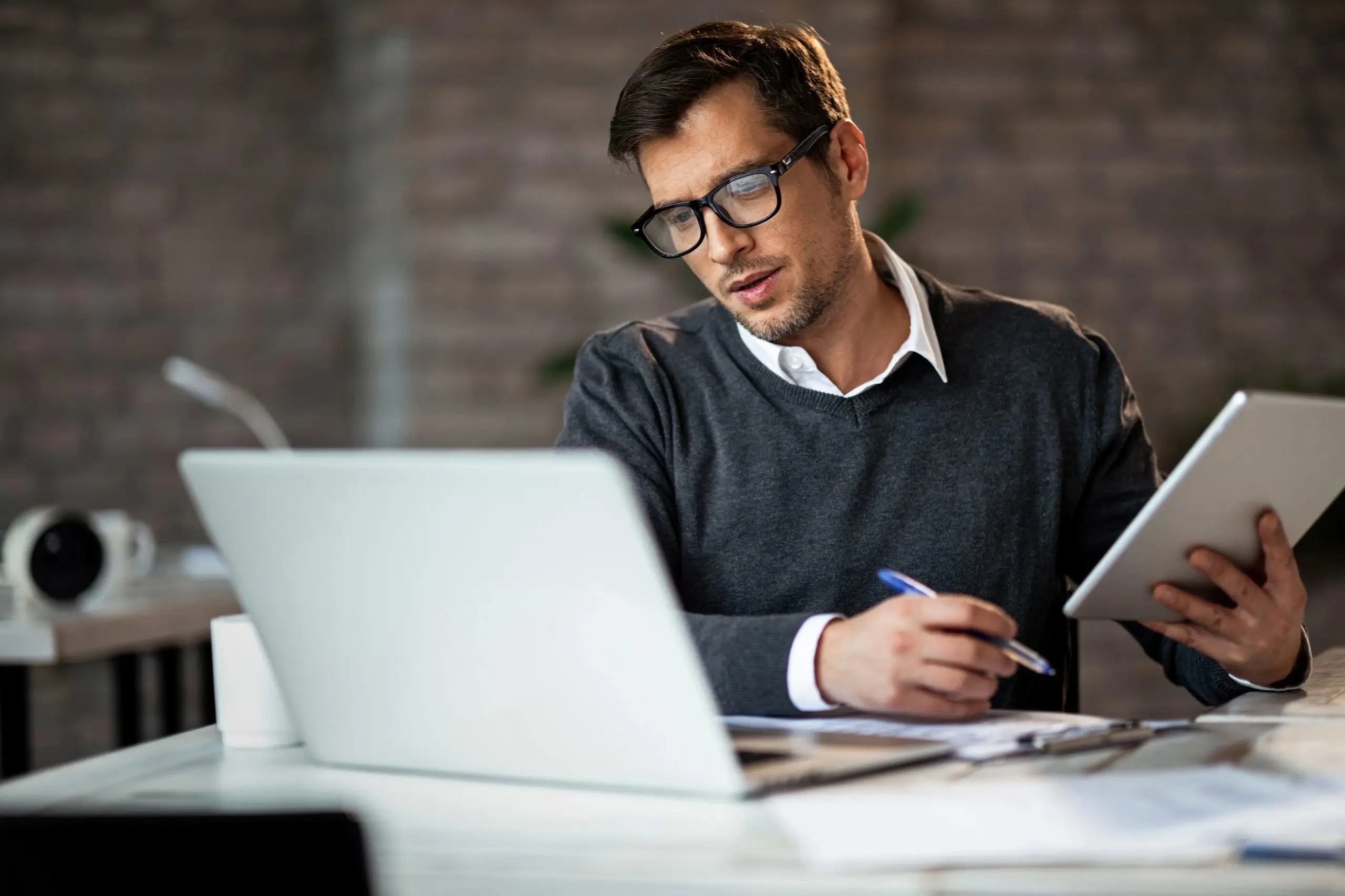 A person working on a laptop with design software