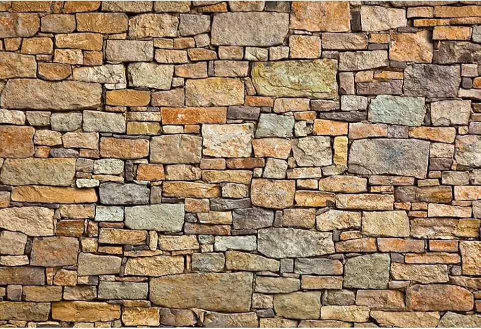 The textural interplay between a stone wall and a smooth metal fixture